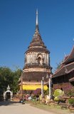 Wat Lok Moli or ‘topknot of the world’ is thought to have been founded by King Ku Na, the 6th king of the Mangrai Dynasty (1263–1578), who ruled the Lan Na Kingdom from Chiang Mai between about 1367 and 1388. It was probably a royal temple, since the northern side of the city was a royal precinct at the time; certainly the sanctuary enjoyed a long and close association with the Mangrai rulers.  According to a notice at the south entrance of the temple, King Ku Na invited a group of ten monks from Burma to come and live in Chiang Mai, providing Lok Moli as a residence for them.<br/><br/> 
 

The huge chedi that distinguishes Lok Moli was built in 1527, perhaps after the orders of the 11th Mangrai monarch, King Muang Kaeo (1495–1526), but apparently during the first year of the first reign of his younger brother, King Ket Chettharat (1526–1538).